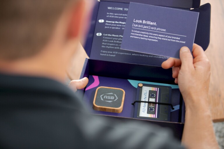 A person opening a branded merchandise kit